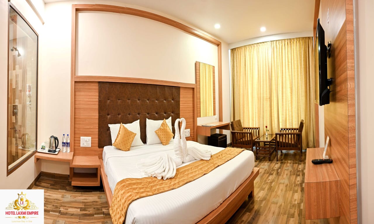 Guest room with seating area at Hotel Laxmi Empire